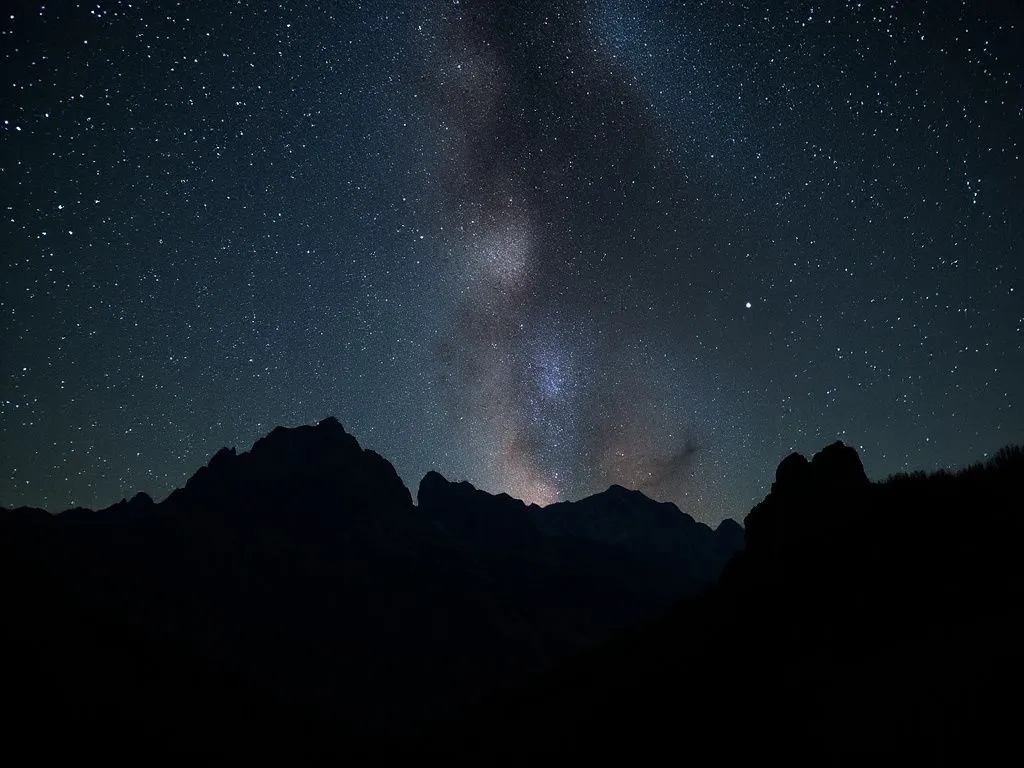 Mountainous landscape silhouetted against a starry night sky, detailed, natural beauty, tranquil setting, perfect for stargazing